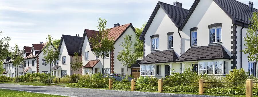 A row of houses lined up in a quiet residential neighborhood, showcasing various architectural styles and colors.