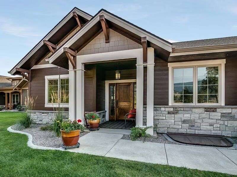 A charming home featuring a welcoming front porch and a well-kept front yard.